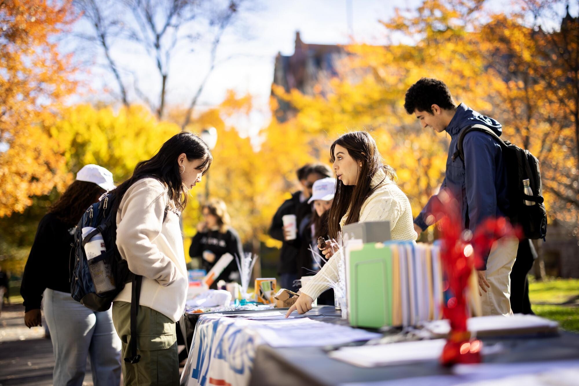 Members of Penn Leads the Vote talking with students on Locust Walk.
