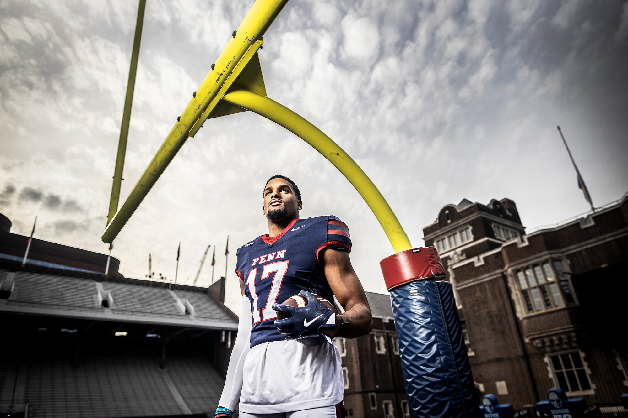 Jared Richardson poses with a football under the goalposts at Franklin field.