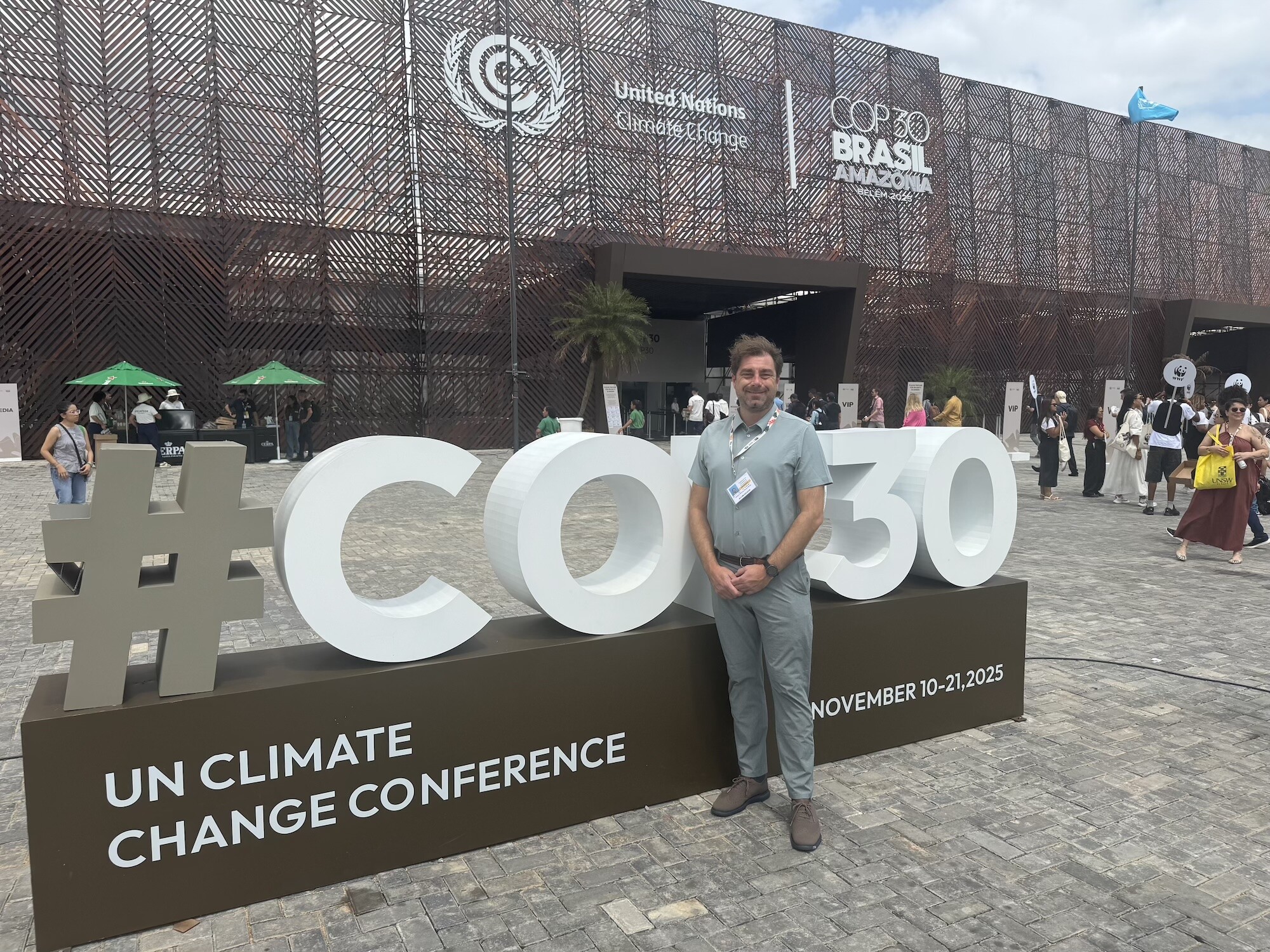 Bill Burke-White in front of COP30 sign.