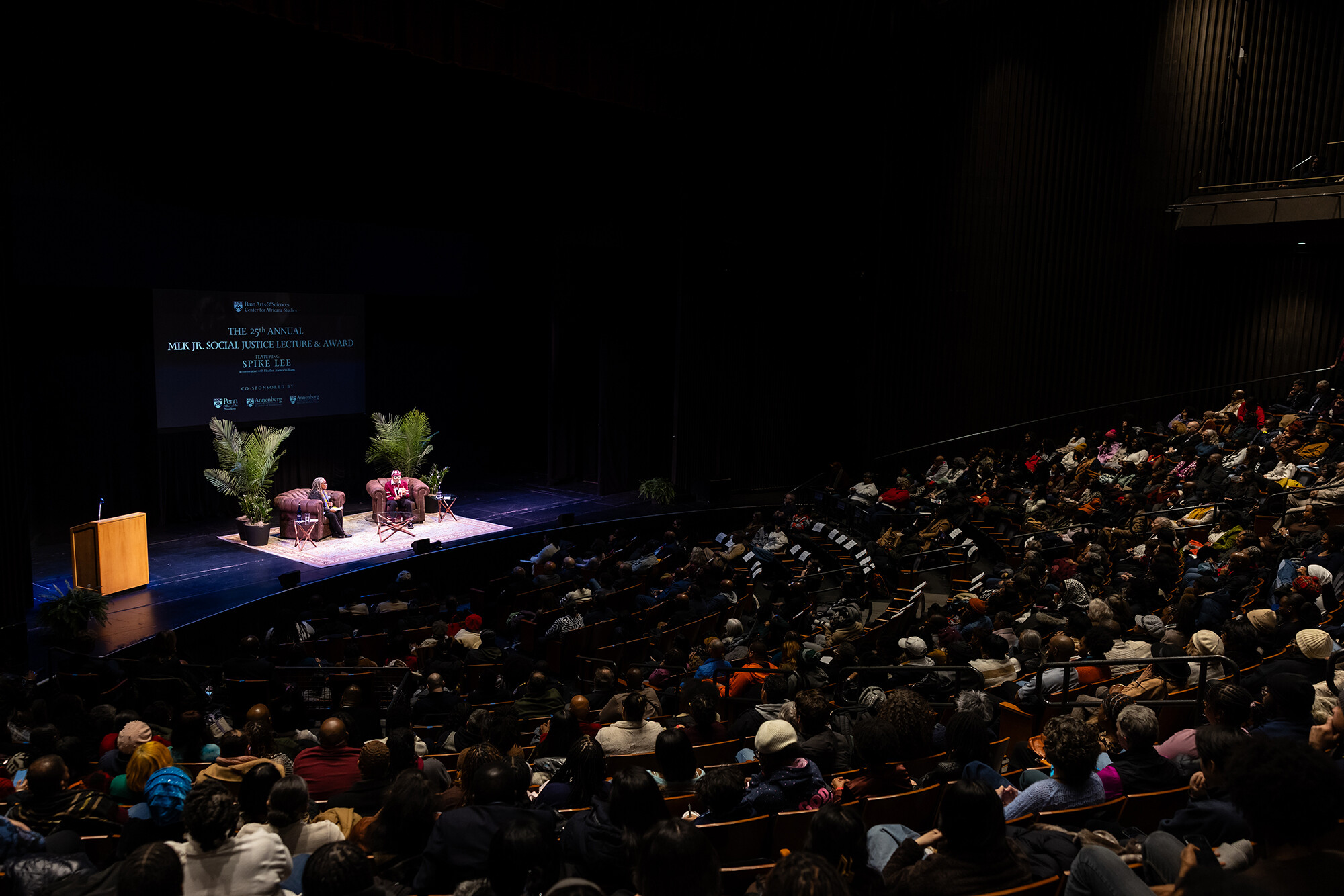 Spike Lee and Heather Williams on the stage in front of a large audience. 