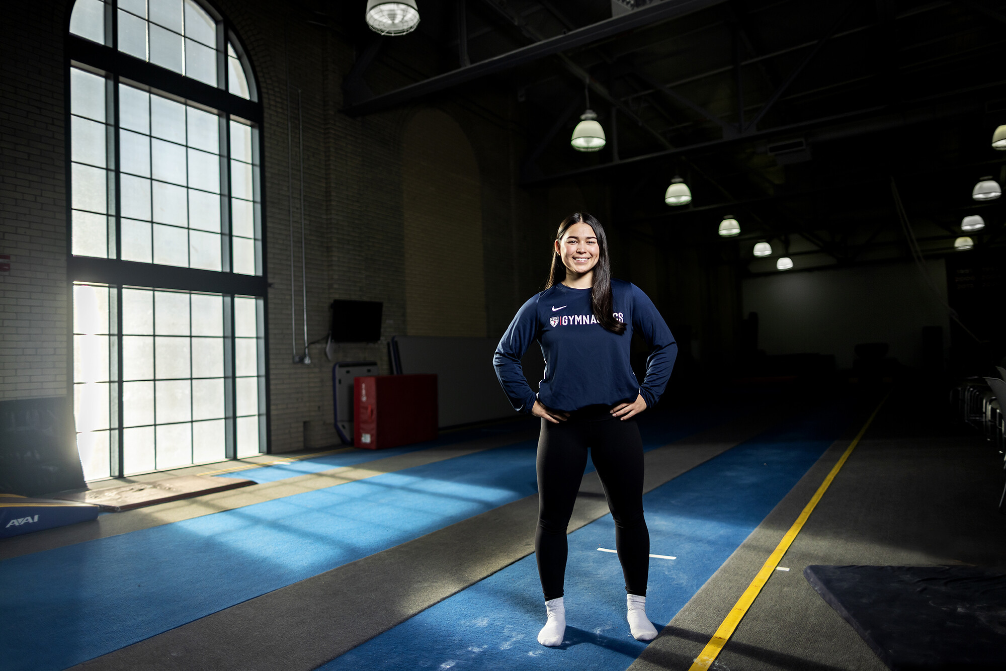 Carly Oniki stands in the gymnastics training center.
