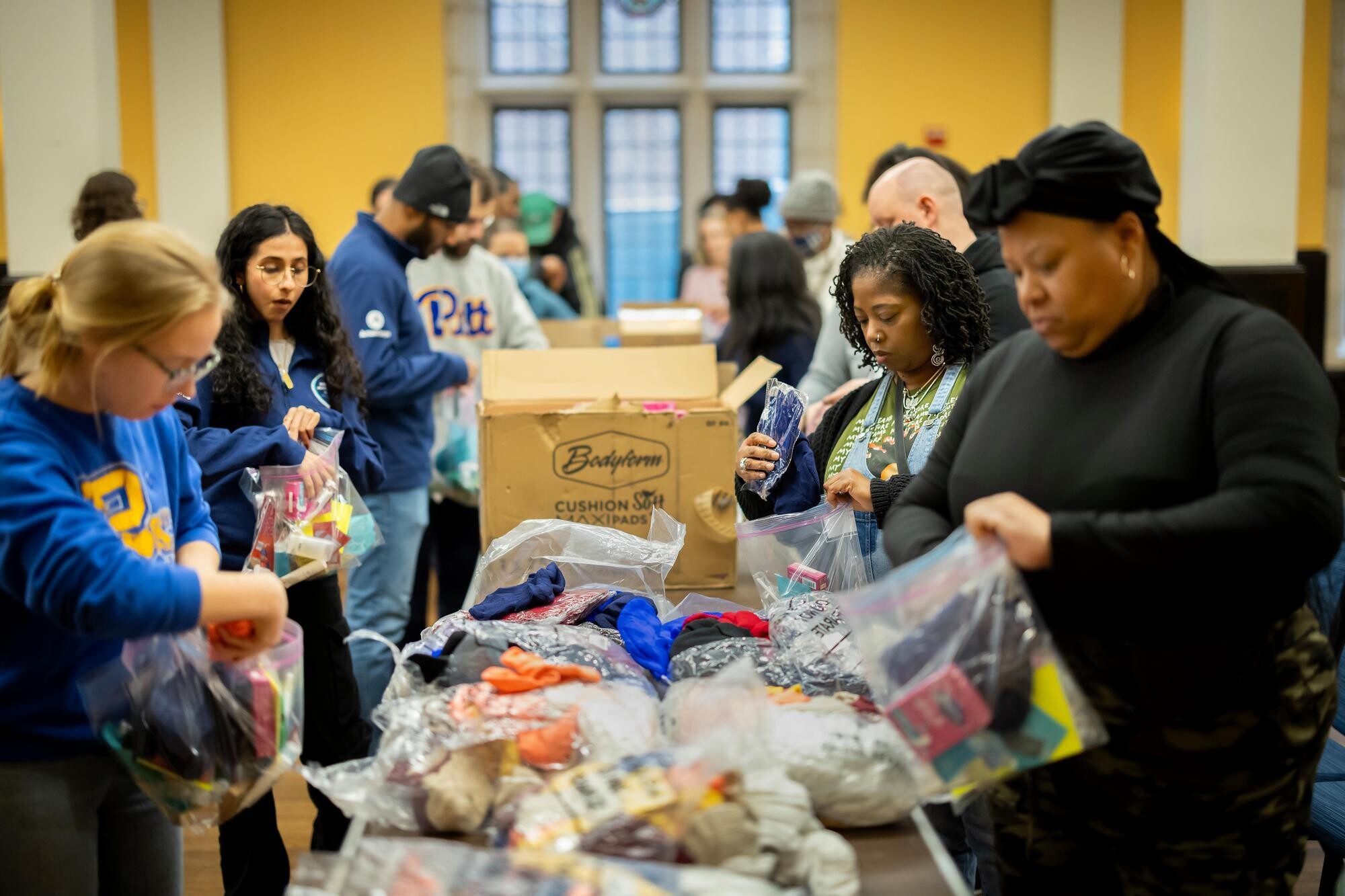 Students, faculty and staff assemble toiletry pouches for people experiencing homelessness.