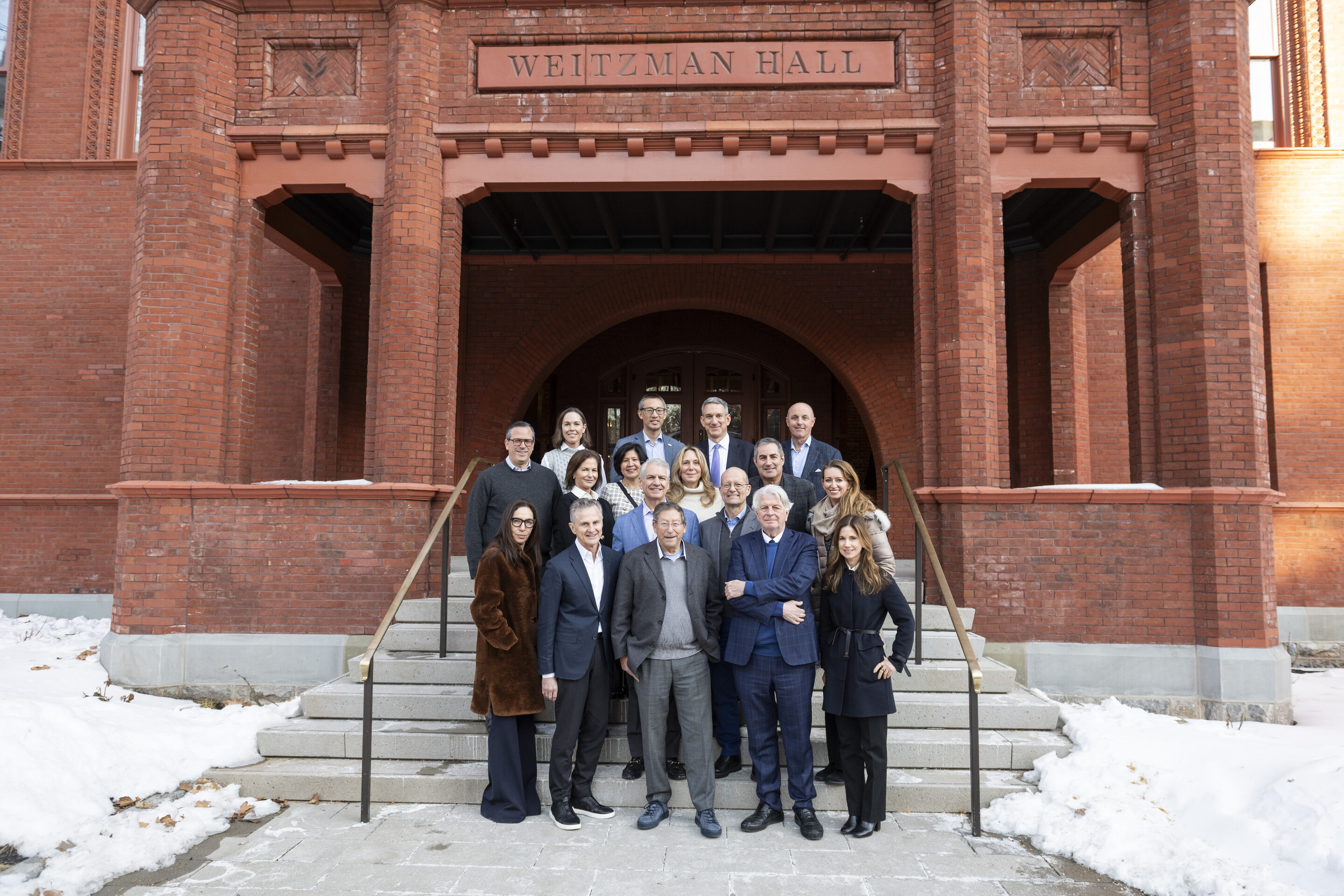 A group shot of Stuart Weitzman, Fritz Steiner and other people associated with the Weitzman School in front of Weitzman Hall. 