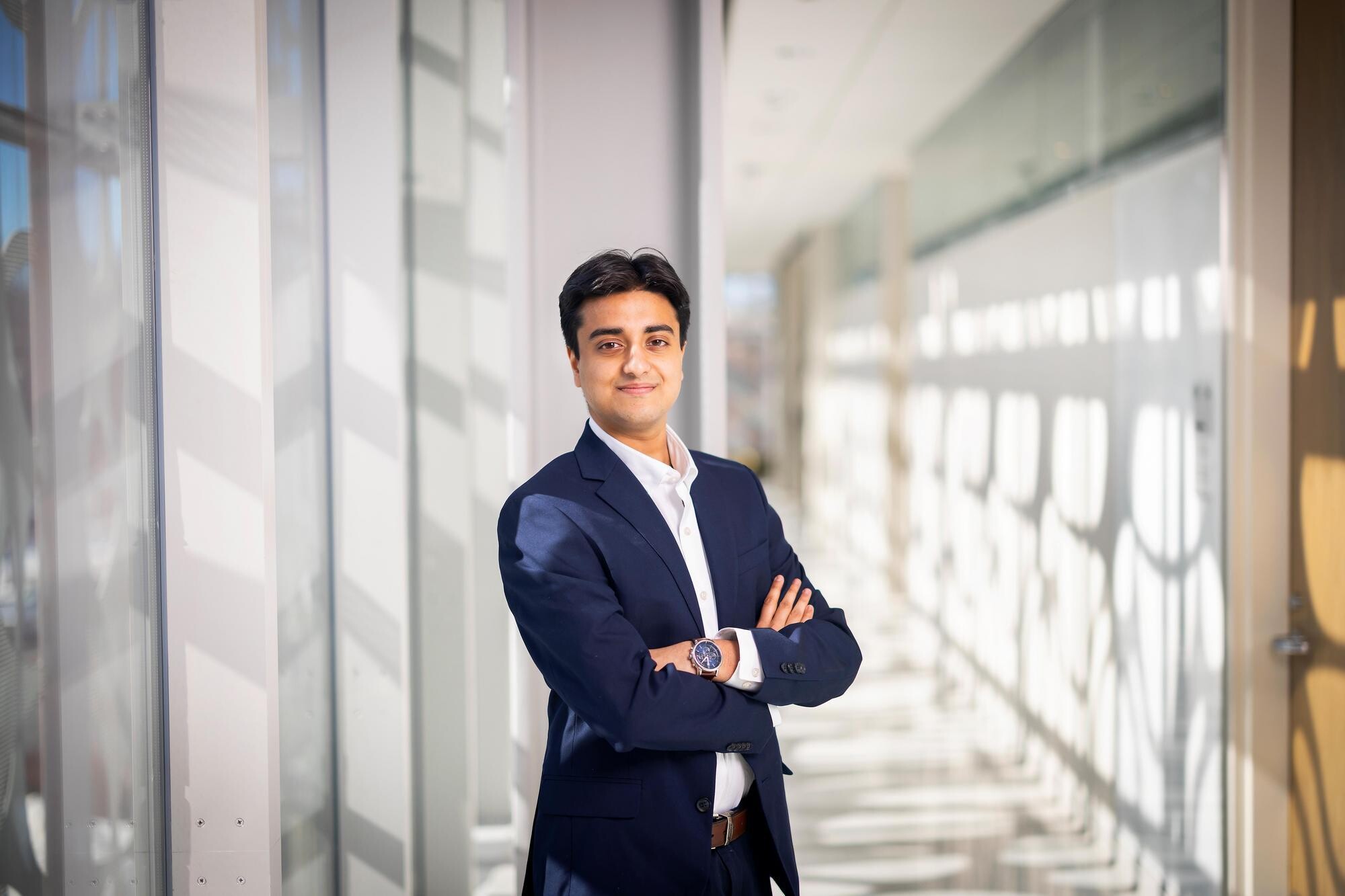 Fourth-year student Prithvi Parthasarathy standing with arms crossed in the Neural and Behavioral Sciences Building