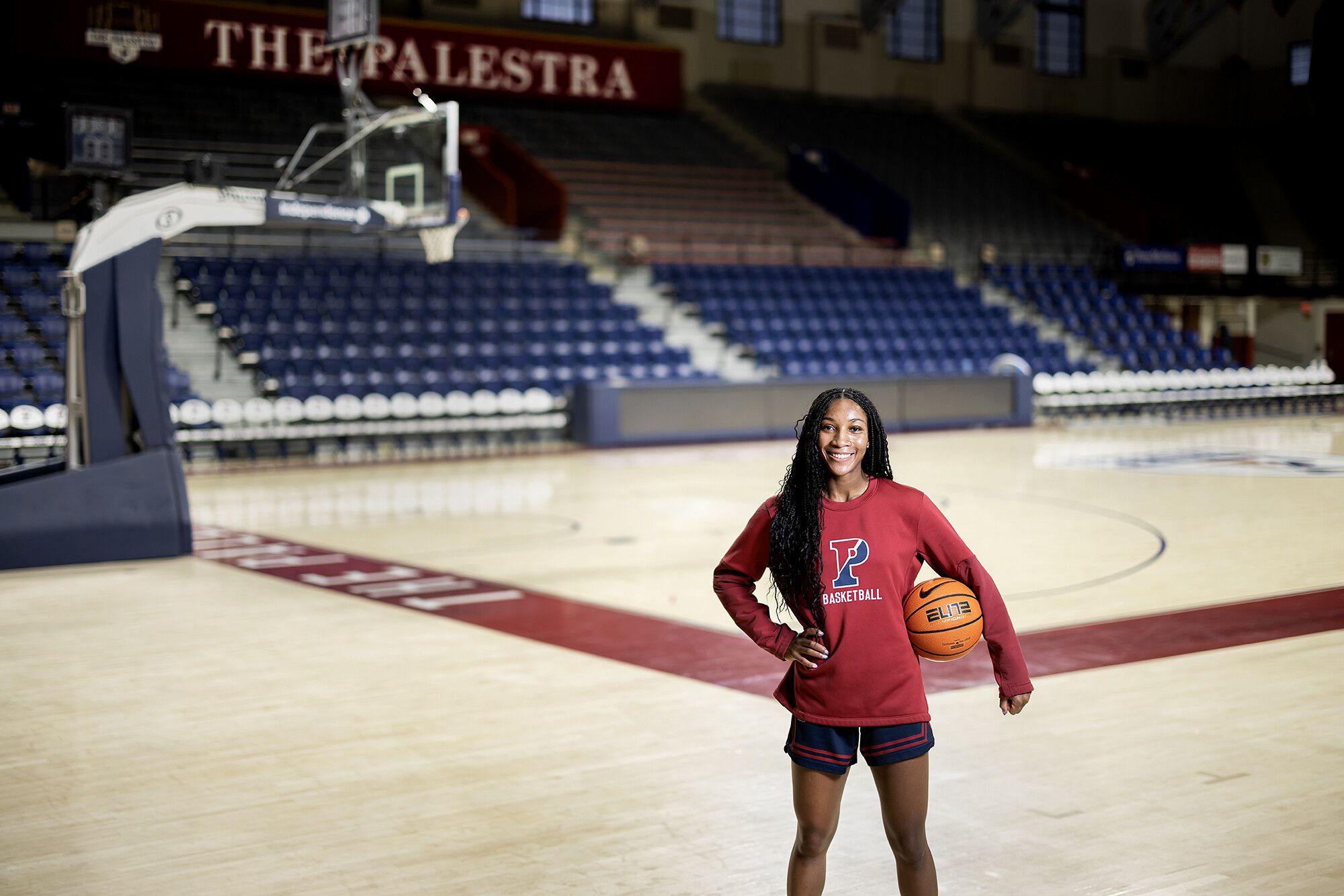 Simone Sawyer holds a basketball while on the court at the Palestra.