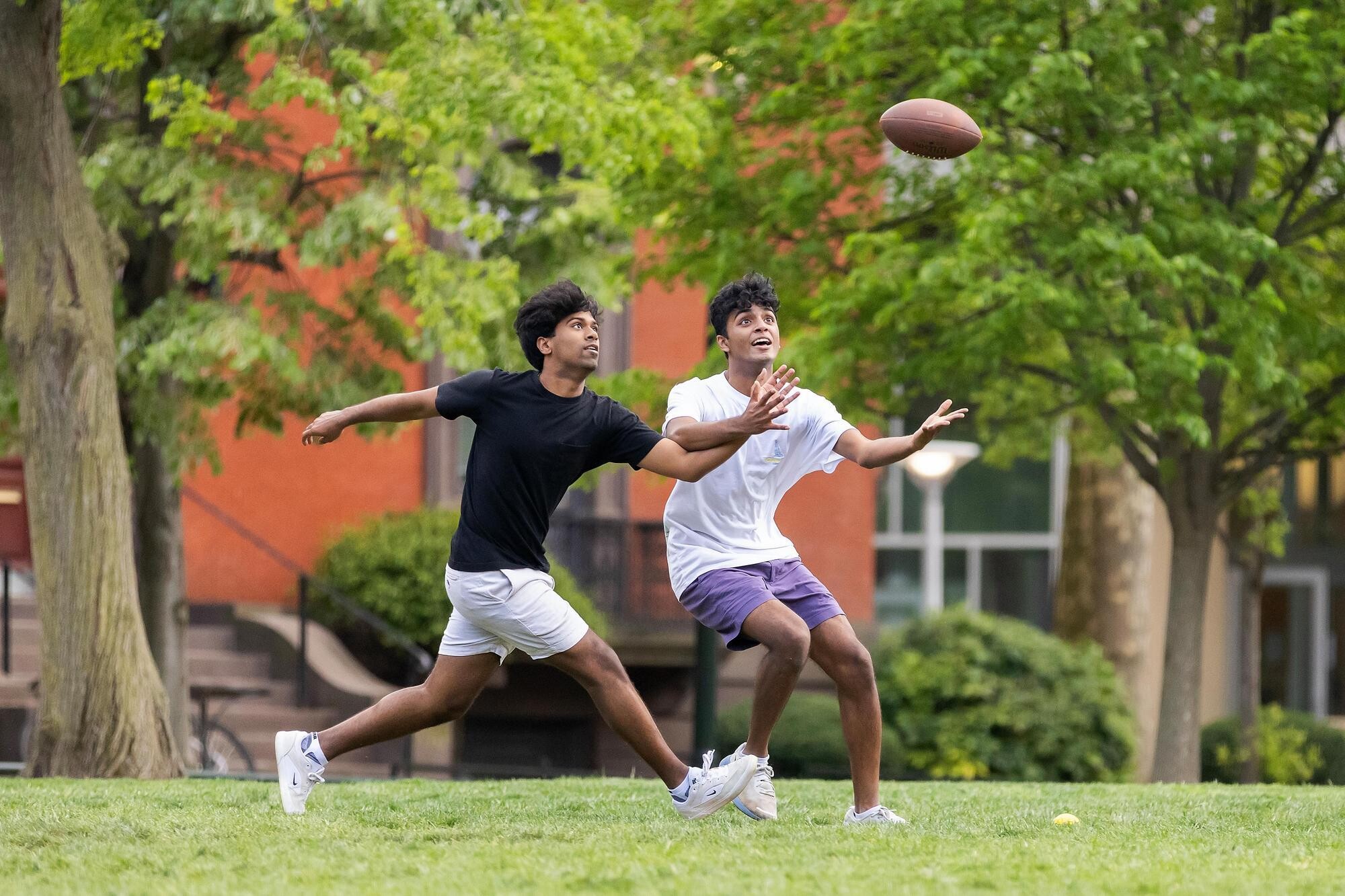 Two Penn students playing football on High Rise Field.