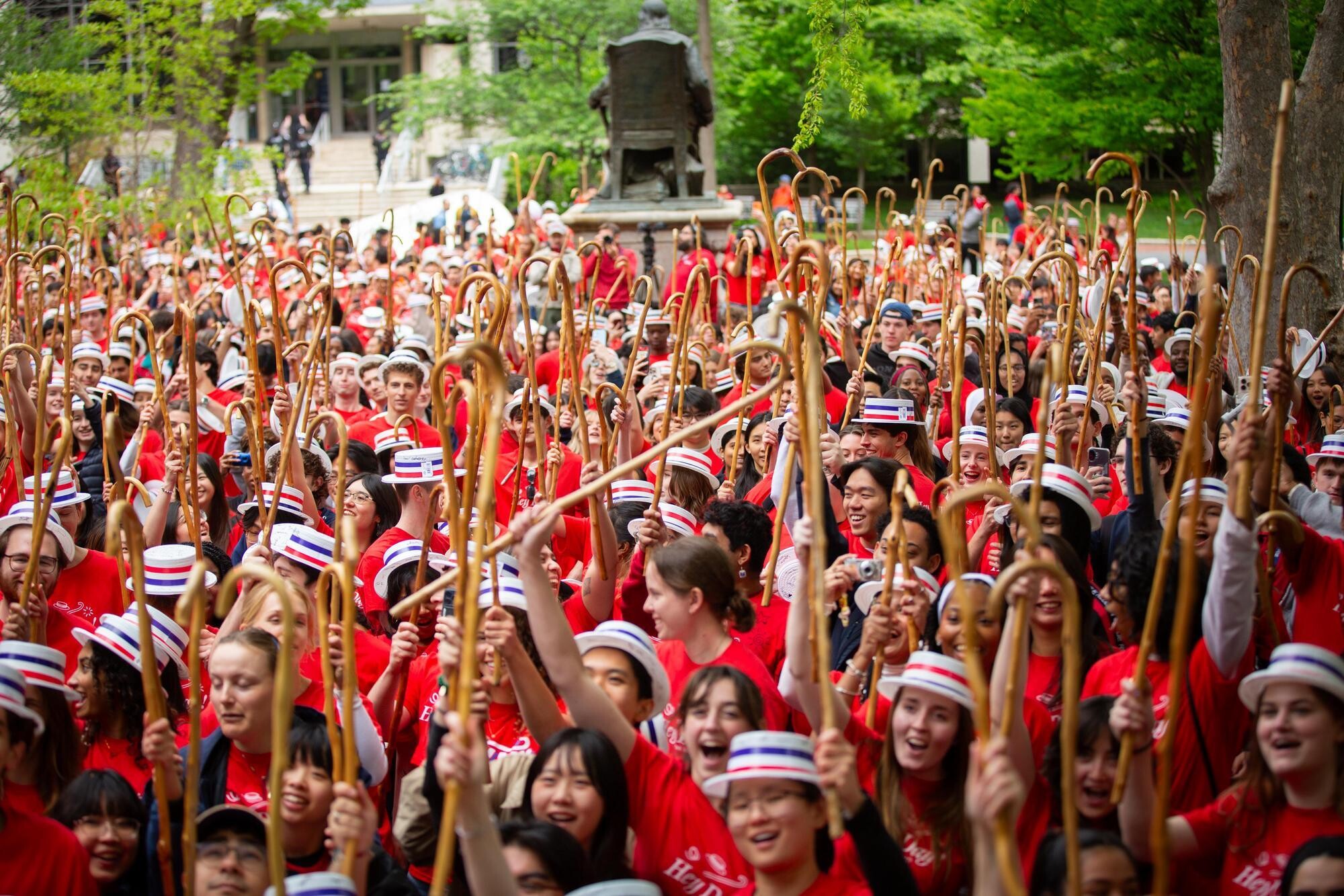 The Class of 2027 on College Green with their canes in the air during Hey Day.