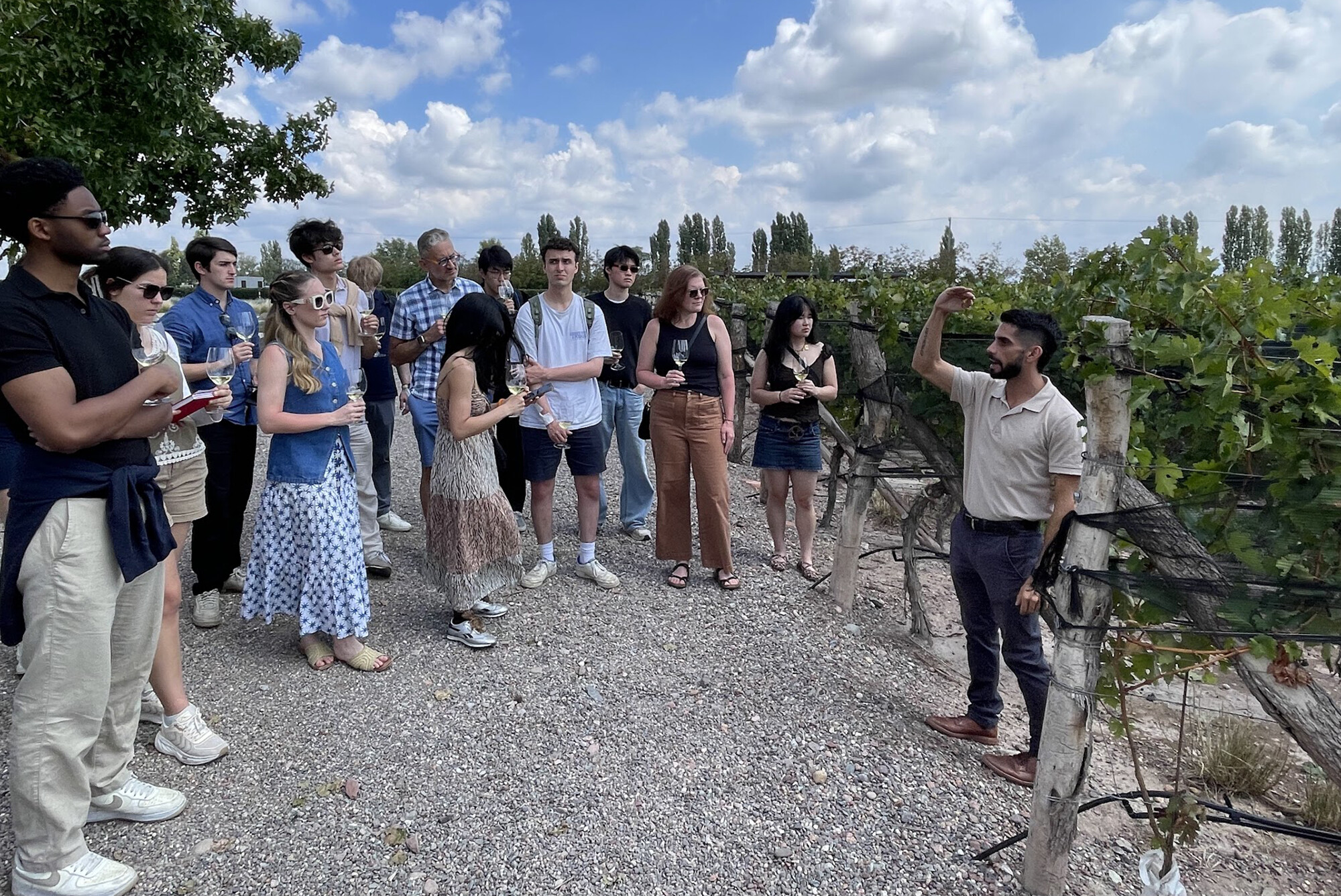 Students listen to explanation at winery.