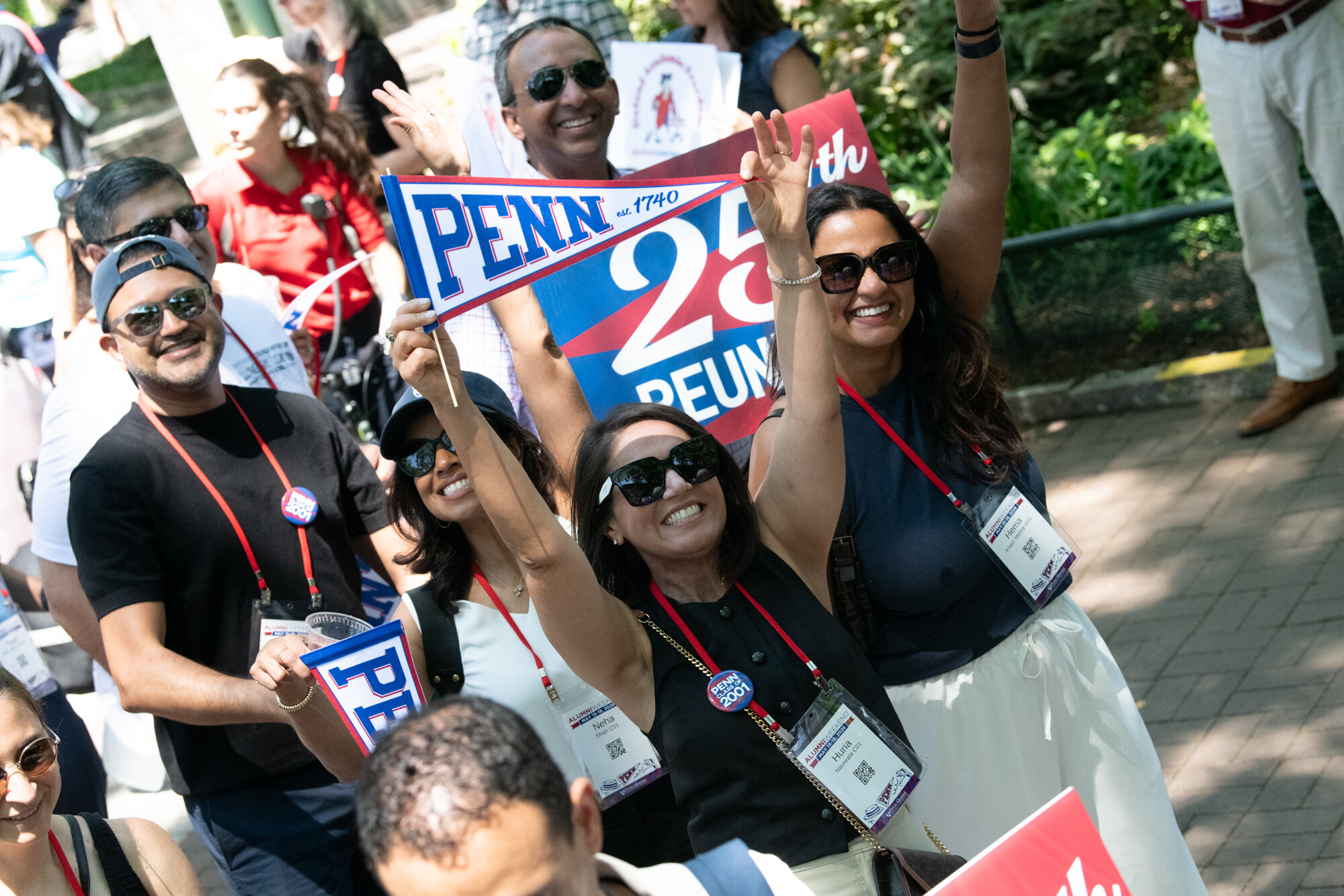 Pen alum holding banners on Locust Walk.