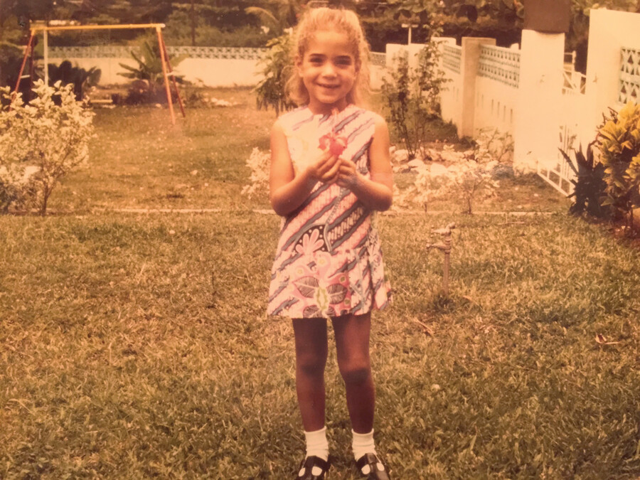 Thomas as a child in her yard in Kingston, Jamaica.
