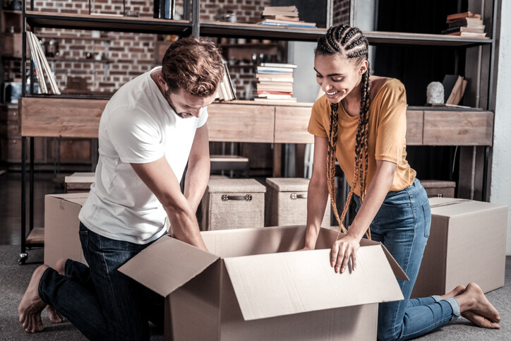 millenial couple packing a box
