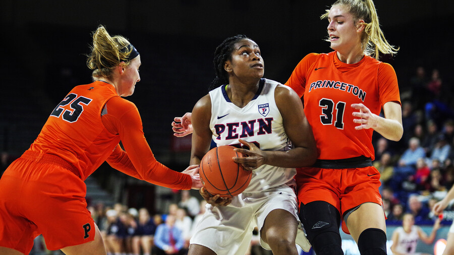 Princess Aghayere prepares to shoot the ball while guarded by two Princeton players.