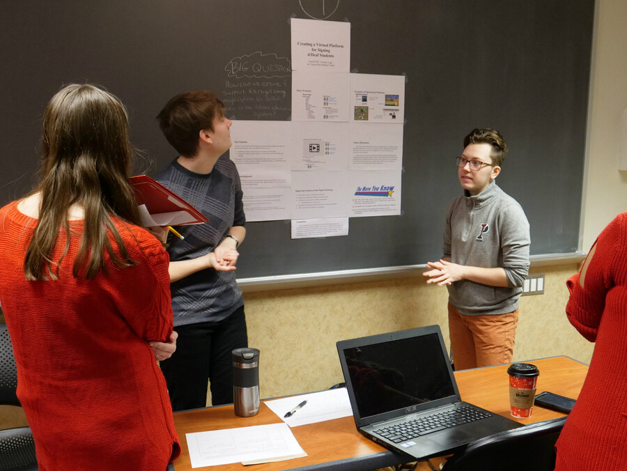 Members of Team PAH explain their project in the classroom