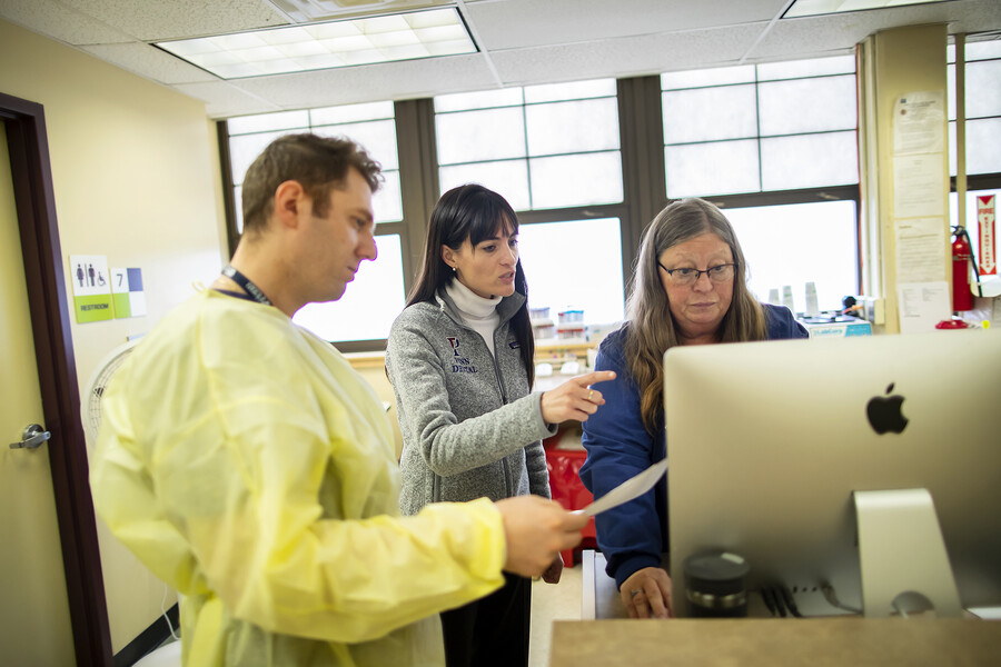 penn dental staff looking at a computer