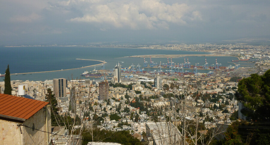 A landscape photo of city and the ocean in the distance. 