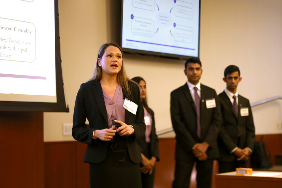Daisak speaks in front of a powerpoint slide
