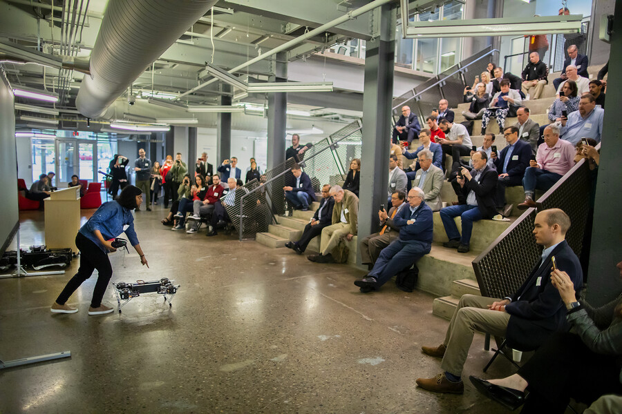 Person demonstrating robot to crowd
