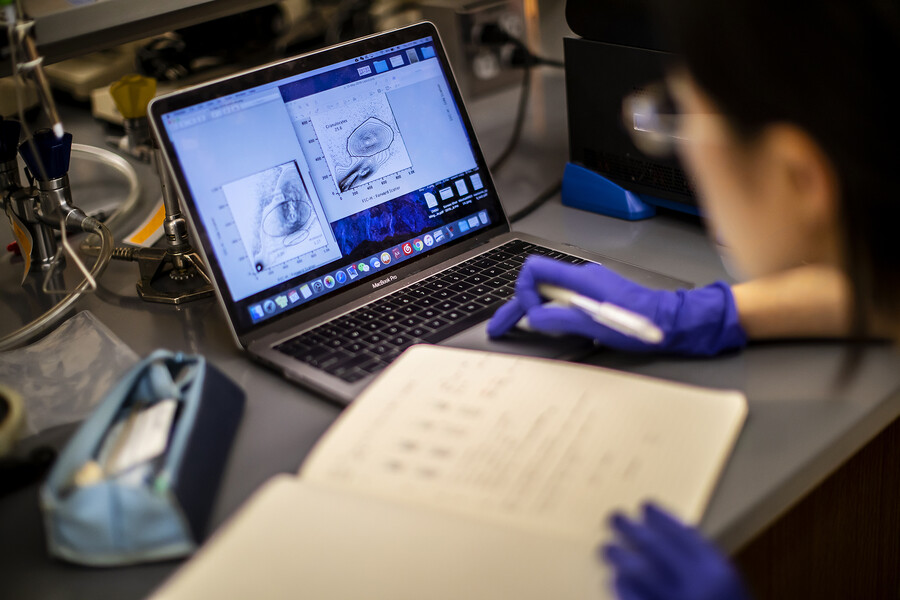 closeup of laptop and notebook at the canine lab