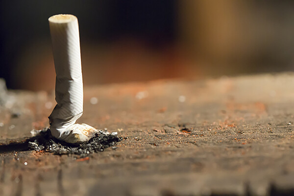 crushed cigarette butt vertical on the ground