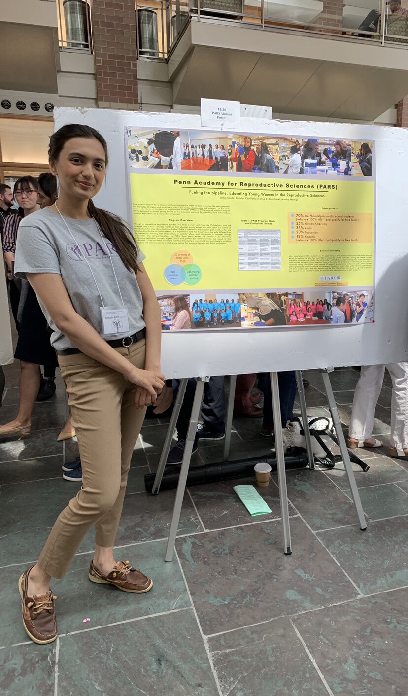 Shezda Afrin stands beside her reproductive science display at a PARS symposium in June