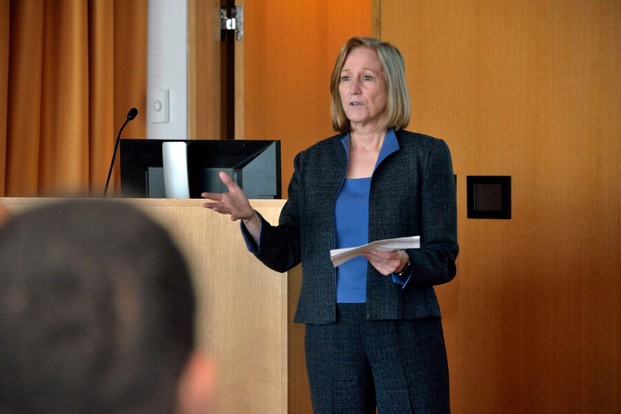 a person standing by a lectern speaking to an audience