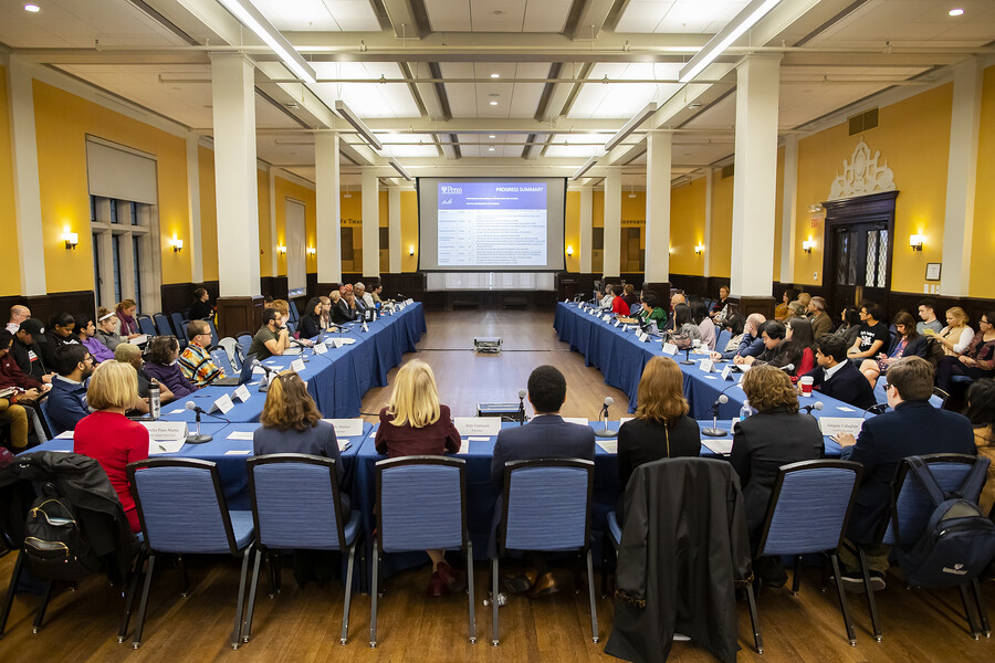 View of University Council at a meeting looking at an informative screen