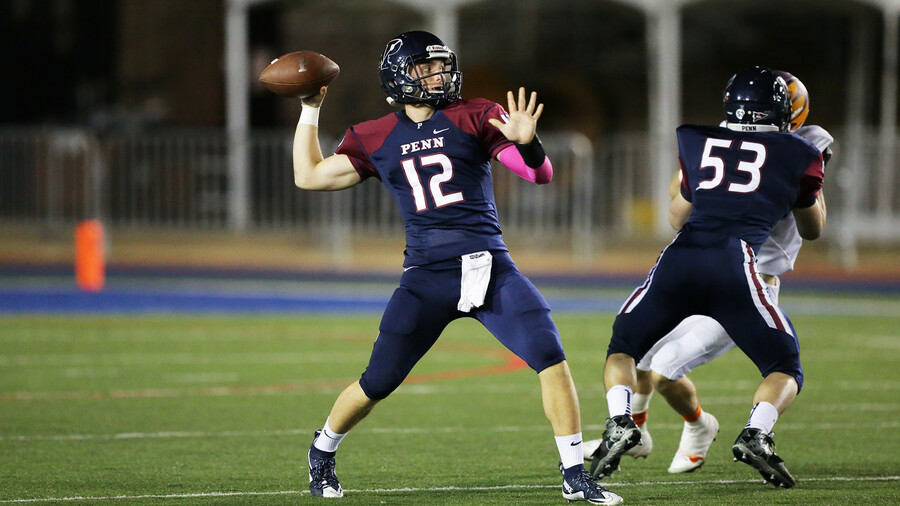 Eddie Jenkins of sprint football prepares to throw a pass during a game.