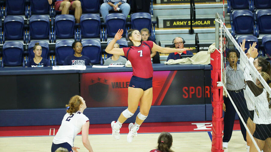 During a match, Parker Jones jumps in the air and prepares to hit the ball.