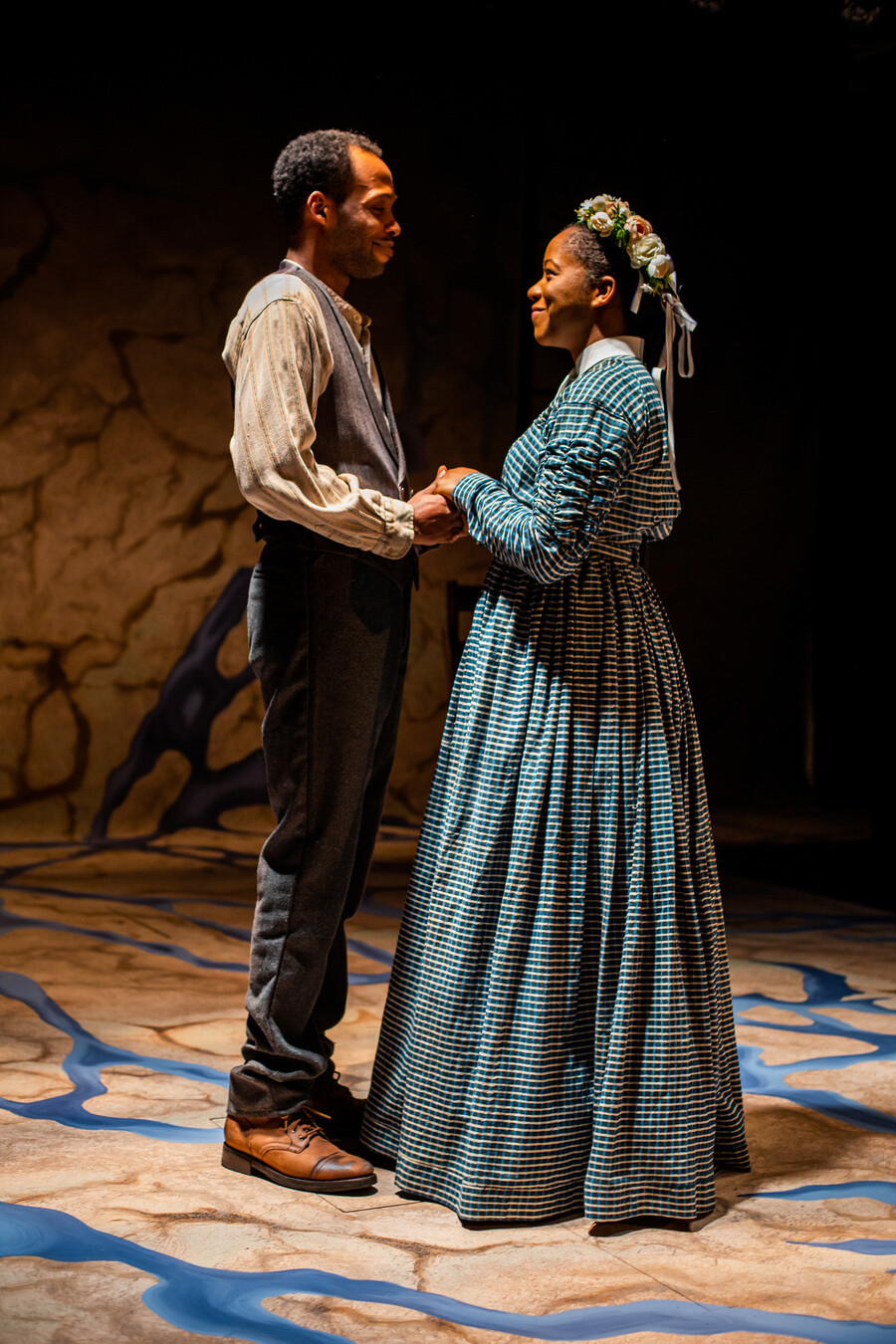 Brandon Pierce and Danielle Leneé perform on stage facing each other holding hands