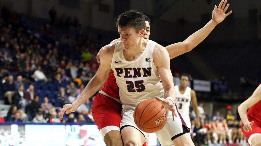 AJ Brodeur dribbles the ball to the basket during a game.