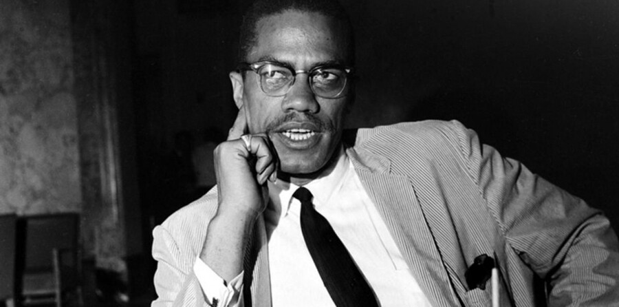 Malcolm X wearing a suit.
