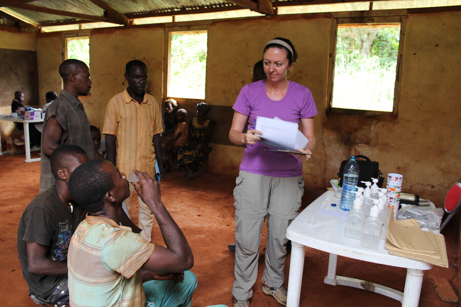 Scientist oversees study participants consuming a drink as part of a research project
