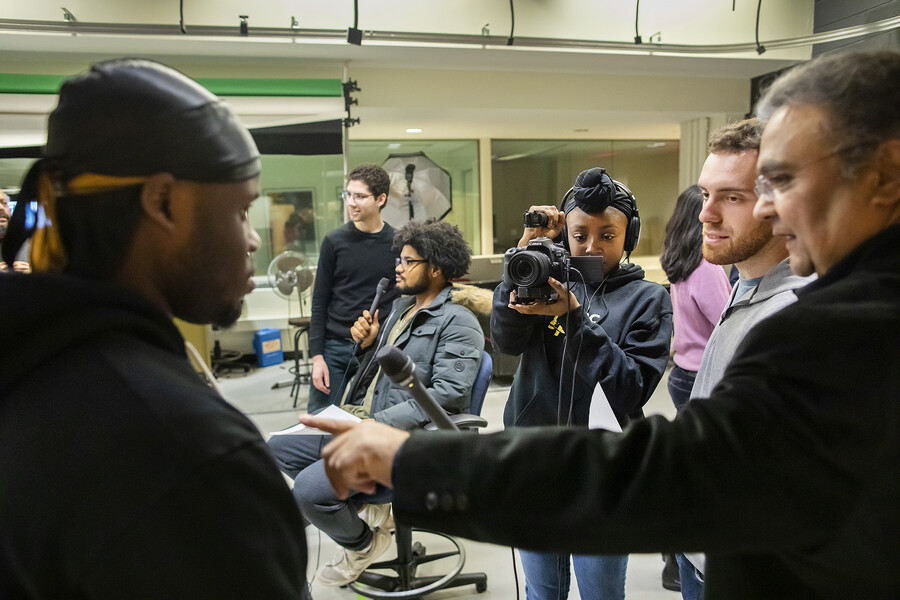 Amitanshu Das helping a student during filming