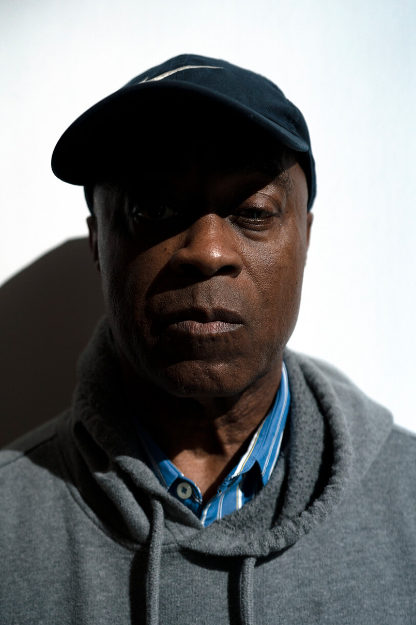 Photo portrait of Charles Burnett in a baseball hat and grey hoodie.
