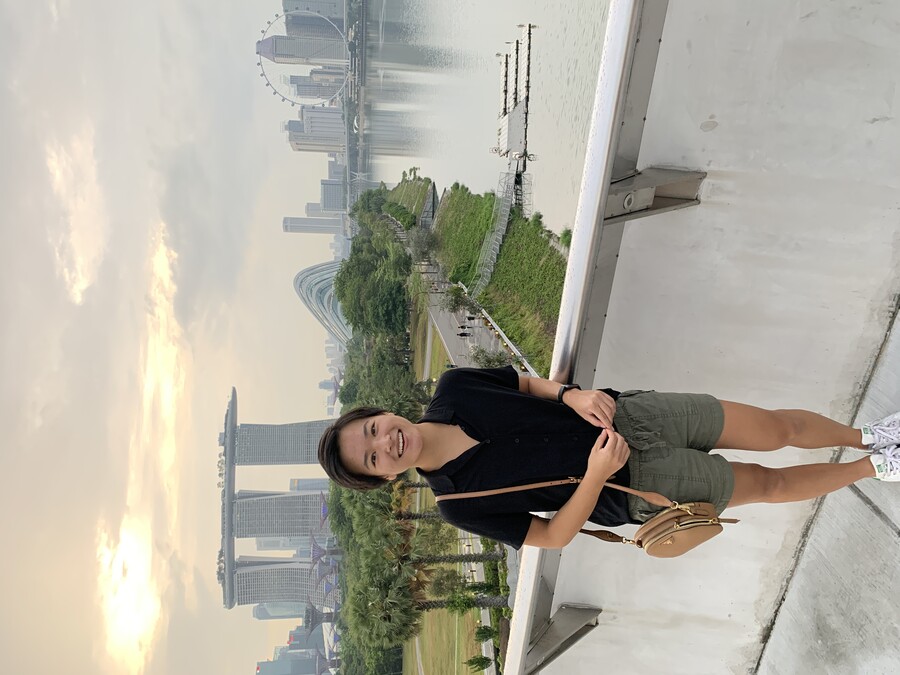 Jackie Shi stands in front of Marina Bay Sands in Singapore.