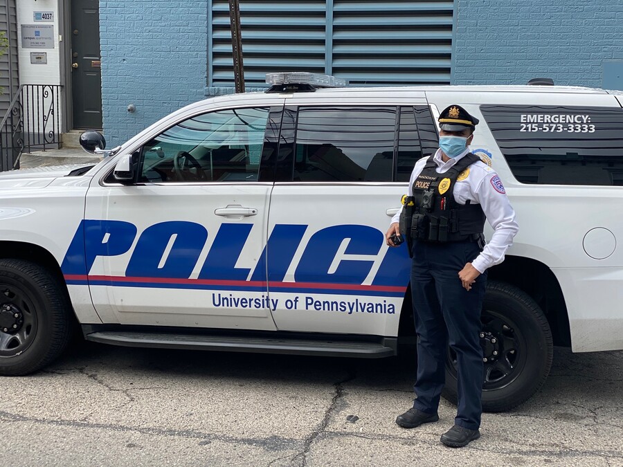 Lt. Nicole McCoy standing in front of a Penn police car with a face covering on.