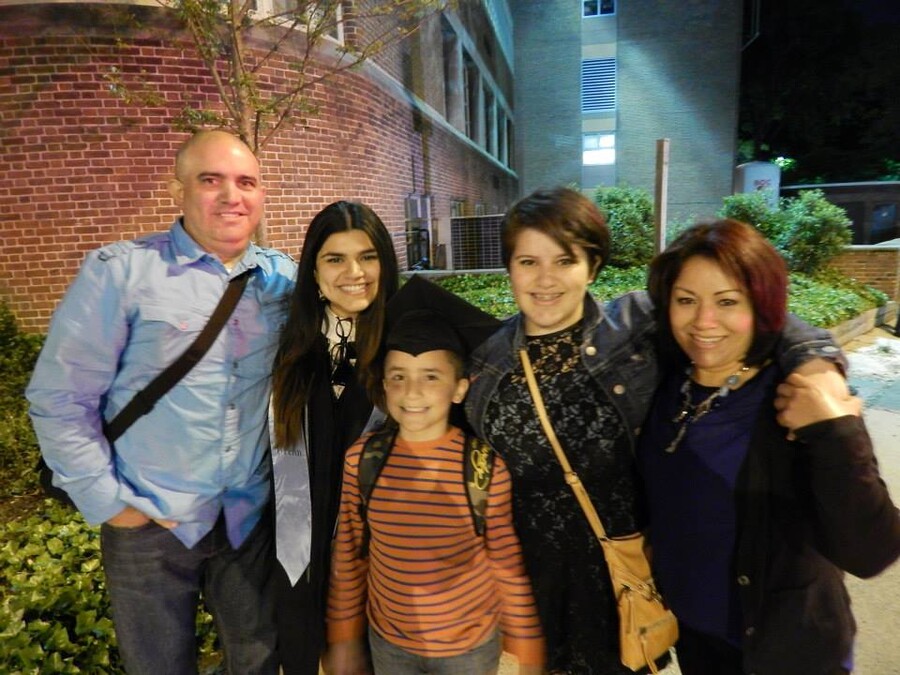 Five people in front of a brick building