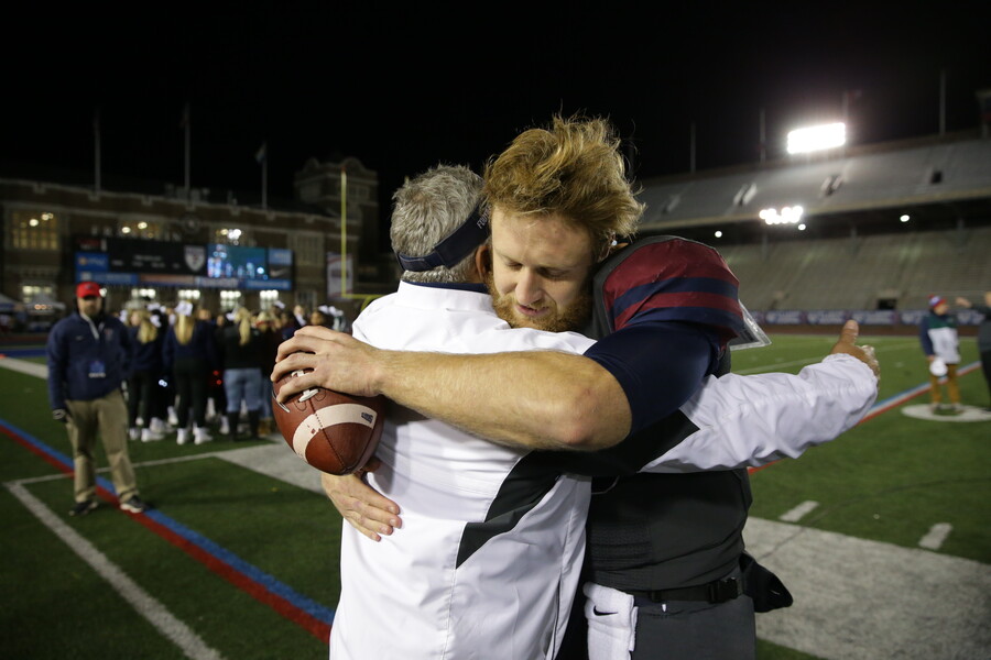 Alek Torgersen embraces Coach Ray Priore on Senior Night in 2016.