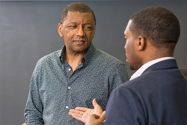 Howard Stevenson listens as a colleague talks to him.