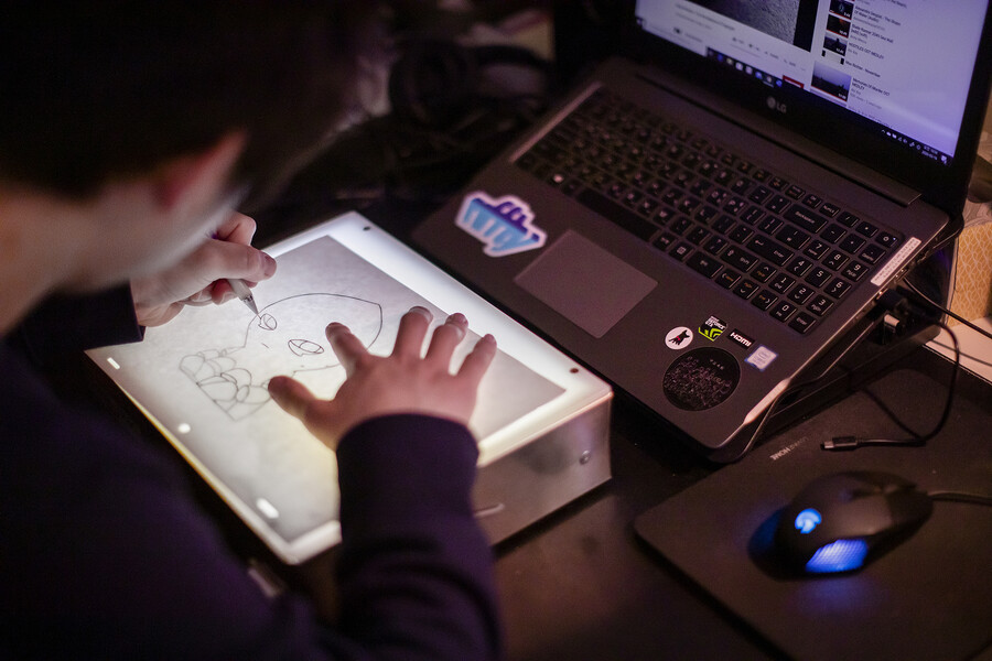 dennis kim illustrating on a light table