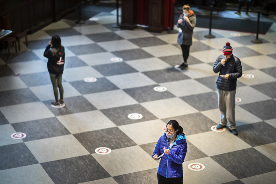 Socially distanced students waiting to take COVID tests at Houston Hall