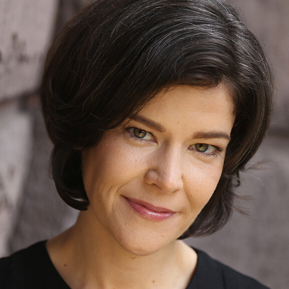 A close-up image of a person outside. 