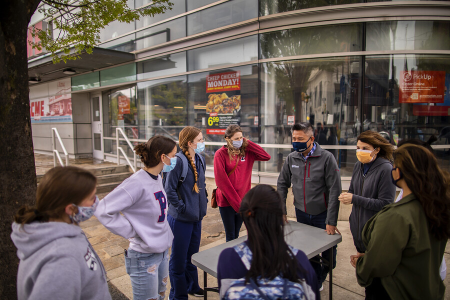 students gather before handing out masks on walnut street