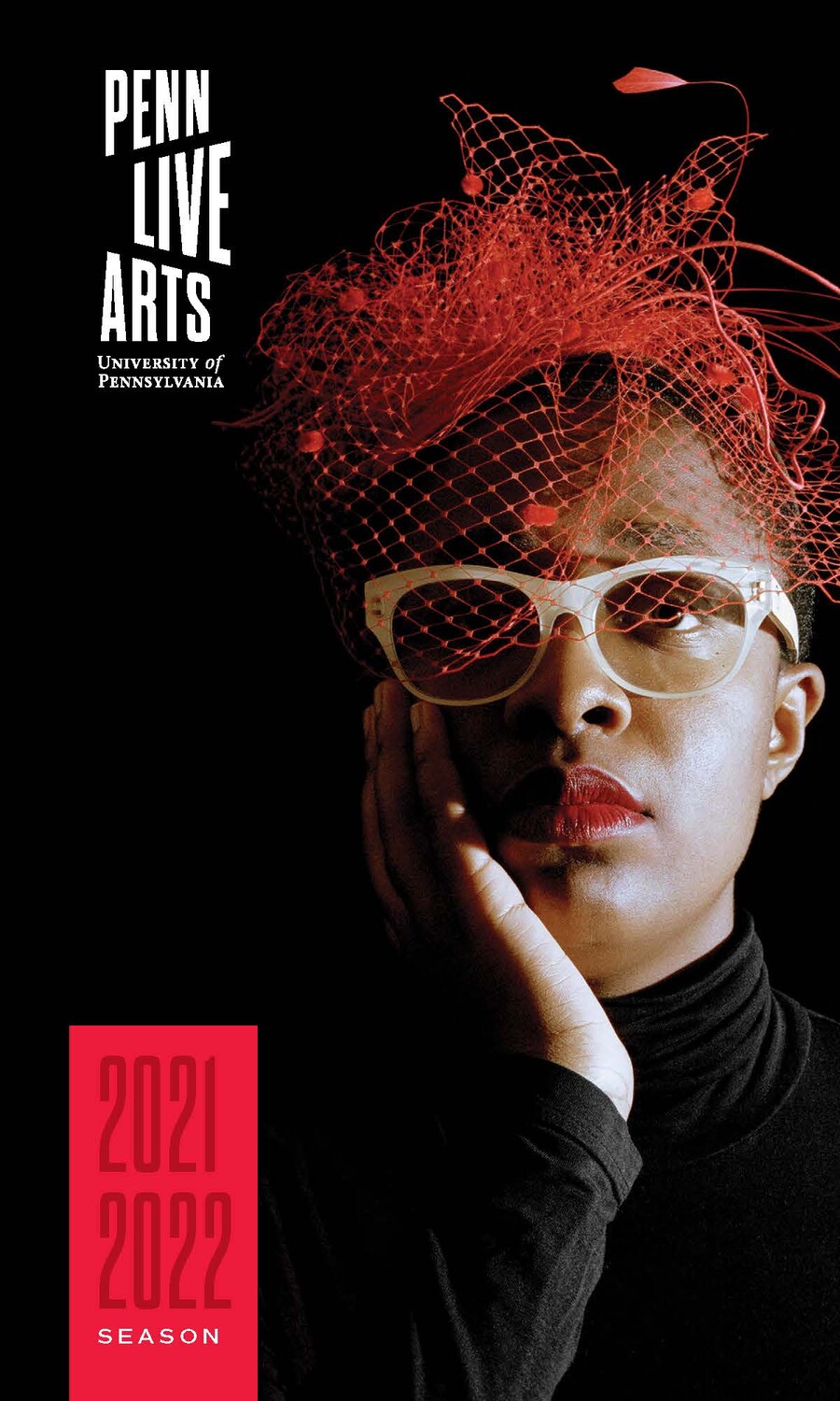 Woman in net hat with red lipstick and white glasses staring forward
