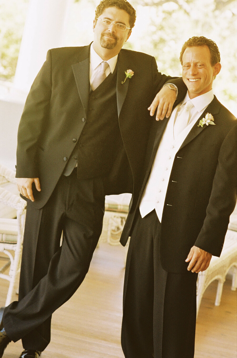 Two people dressed in tuxedos