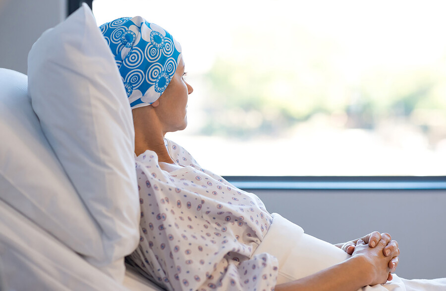 cancer patient in bed looking out window