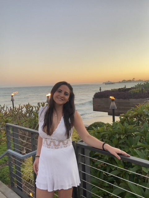 student standing outside with ocean in the background