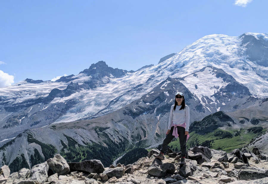 Xunjing Wu posing in front of Mt. Rainier.