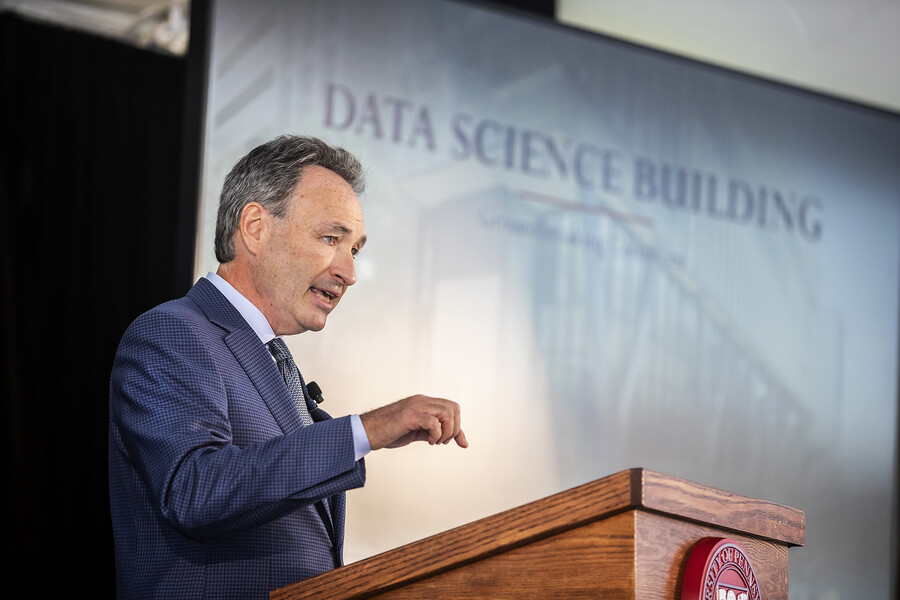 harlan stone in front of a presentation that reads data science building