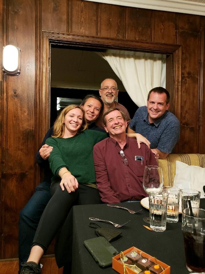 Smiling family embraces and poses together during a celebration